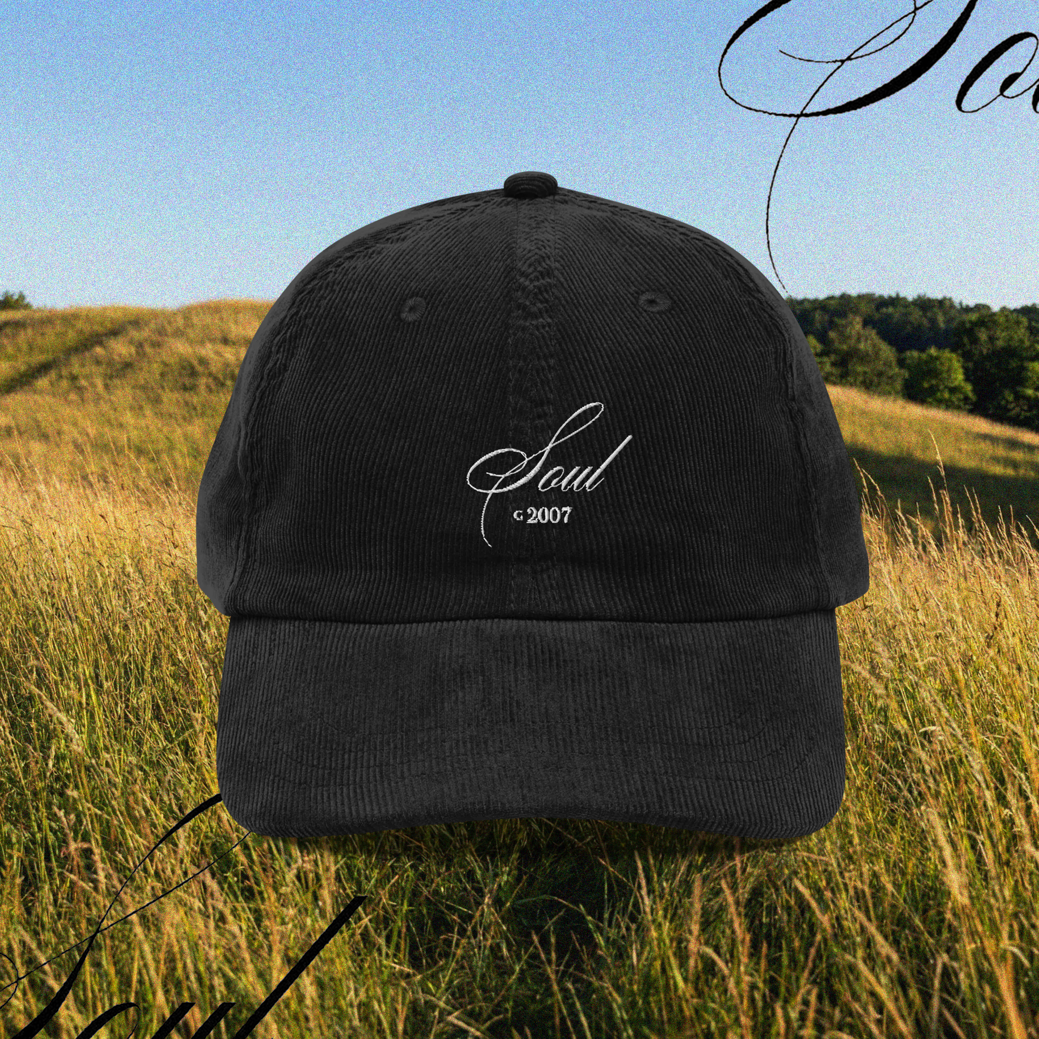 Black cap with a logo that reads: "SOUL" with white text on a grassy field on a blurred background